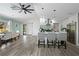 Modern kitchen with hardwood floors, a breakfast bar, and stylish lighting at 5298 Florentine Ct, Spring Hill, FL 34608