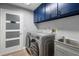 Well-organized laundry room with modern appliances, custom cabinets, and ample storage space at 5298 Florentine Ct, Spring Hill, FL 34608
