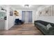 Cozy living room featuring hardwood floors, a comfortable sofa, and stylish decor at 5298 Florentine Ct, Spring Hill, FL 34608