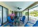 Outdoor patio with blue seating area and a view of the screened-in pool, perfect for relaxation at 5298 Florentine Ct, Spring Hill, FL 34608