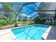Relax in this sparkling private pool enclosed with screen, featuring lush landscaping at 5298 Florentine Ct, Spring Hill, FL 34608