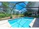 Relax in this sparkling private pool enclosed with screen, featuring lush landscaping at 5298 Florentine Ct, Spring Hill, FL 34608