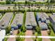 An aerial view displays well-maintained, modern homes with brick driveways and manicured lawns along a bustling road at 5548 Silver Sun Dr, Apollo Beach, FL 33572