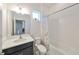 Well-lit bathroom with white tiled shower, dark vanity, and decorative butterfly shower curtain at 5548 Silver Sun Dr, Apollo Beach, FL 33572