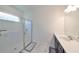 Well-lit bathroom with a glass-enclosed shower and a vanity with modern fixtures at 5548 Silver Sun Dr, Apollo Beach, FL 33572