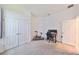 Bright bedroom features plush carpeting, closet, and an adjacent workstation area with a desk at 5548 Silver Sun Dr, Apollo Beach, FL 33572