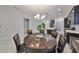 Bright dining area featuring a unique table and view of the open concept kitchen at 5548 Silver Sun Dr, Apollo Beach, FL 33572