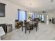 Bright dining area features a modern chandelier and flows seamlessly into the living room at 5548 Silver Sun Dr, Apollo Beach, FL 33572
