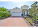 Charming single-Gathering home with a brick driveway and manicured landscaping at 5548 Silver Sun Dr, Apollo Beach, FL 33572