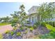 Landscaped front yard with a brick walkway leading to the front door and lush plants and mulch at 5548 Silver Sun Dr, Apollo Beach, FL 33572
