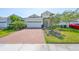 Inviting single-Gathering home with a brick driveway, lush lawn, and a two-car garage at 5548 Silver Sun Dr, Apollo Beach, FL 33572