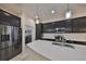 Bright, modern kitchen with stainless steel appliances, a large island and a view of the laundry area at 5548 Silver Sun Dr, Apollo Beach, FL 33572