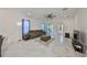 Spacious living room with large windows and a ceiling fan, ideal for entertaining at 5548 Silver Sun Dr, Apollo Beach, FL 33572