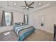 Comfortable main bedroom with trey ceiling, ceiling fan and ensuite bathroom at 5548 Silver Sun Dr, Apollo Beach, FL 33572