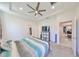 Bright main bedroom boasts a tray ceiling, ceiling fan, and neutral decor at 5548 Silver Sun Dr, Apollo Beach, FL 33572