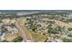 Expansive aerial view of a residential neighborhood with mature trees and a community pond at 6302 Silver Oaks Dr, Zephyrhills, FL 33542