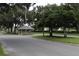 View of the community entrance with mature trees and guard house at 6302 Silver Oaks Dr, Zephyrhills, FL 33542