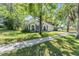 Beautifully landscaped home with mature trees and a well-maintained lawn at 6302 Silver Oaks Dr, Zephyrhills, FL 33542