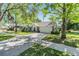 Charming single-story home featuring lush landscaping, a two-car garage and a long driveway at 6302 Silver Oaks Dr, Zephyrhills, FL 33542