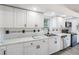 Modern kitchen boasts white cabinetry, sleek countertops, and black appliances at 6302 Silver Oaks Dr, Zephyrhills, FL 33542