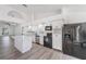 Bright kitchen with an island, black appliances, and sleek white cabinetry at 6302 Silver Oaks Dr, Zephyrhills, FL 33542
