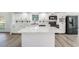 Stylish kitchen featuring white cabinets, marble countertops, and stainless steel appliances at 6302 Silver Oaks Dr, Zephyrhills, FL 33542