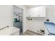 Functional laundry room featuring cabinets, sink, and easy access to the garage at 6302 Silver Oaks Dr, Zephyrhills, FL 33542