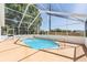 Enclosed swimming pool with clear blue water and a screened enclosure, perfect for outdoor relaxation at 6302 Silver Oaks Dr, Zephyrhills, FL 33542