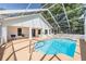 Screened in pool features lounge area, privacy, and sparkling clean water at 6302 Silver Oaks Dr, Zephyrhills, FL 33542