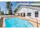 Relaxing screened-in pool area featuring a spacious deck and lush landscaping at 6302 Silver Oaks Dr, Zephyrhills, FL 33542