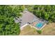 Aerial shot of a screened-in pool area featuring a blue swimming pool at 6302 Silver Oaks Dr, Zephyrhills, FL 33542