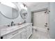 Bathroom boasts a dual sink vanity, white subway tile shower, and modern fixtures at 6600 121St Ave # 4, Largo, FL 33773