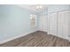 Bright bedroom with wood floors, a large window, and two closets at 6600 121St Ave # 4, Largo, FL 33773