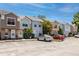 A row of townhomes showcases neat landscaping, reserved parking, and a vibrant blue sky on a sunny day at 6600 121St Ave # 4, Largo, FL 33773