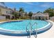 Community pool surrounded by lush landscaping and townhomes at 6600 121St Ave # 4, Largo, FL 33773