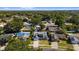 Aerial view of residence with pool, deck, solar panels, and surrounding neighborhood in Florida at 7025 Orkney N Ave, St Petersburg, FL 33709