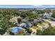 Real estate aerial view of residence with pool, deck, and solar panels in Florida neighborhood at 7025 Orkney N Ave, St Petersburg, FL 33709