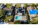 Bird's eye real estate view of house with pool, deck, and solar panels in residential area at 7025 Orkney N Ave, St Petersburg, FL 33709