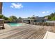 Relaxing backyard boasts a beautiful pool, spacious wooden deck, and inviting outdoor space at 7025 Orkney N Ave, St Petersburg, FL 33709