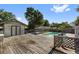 A backyard featuring a pool, wooden deck, and a shed provides a delightful outdoor retreat at 7025 Orkney N Ave, St Petersburg, FL 33709