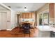 Cozy dining area features wood floors, a round table, and natural light at 7025 Orkney N Ave, St Petersburg, FL 33709