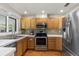Kitchen with stainless steel appliances and wood cabinets at 7025 Orkney N Ave, St Petersburg, FL 33709
