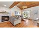 A well-lit living room showcasing hardwood floors, fireplace and a cozy seating area at 7025 Orkney N Ave, St Petersburg, FL 33709