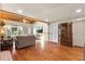 A cozy living room featuring hardwood floors, comfortable sofas, and natural light at 7025 Orkney N Ave, St Petersburg, FL 33709