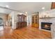 An open-concept living area with a fireplace, display cases, and access to kitchen at 7025 Orkney N Ave, St Petersburg, FL 33709