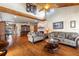 A spacious living room featuring hardwood floors, a fireplace, and high ceilings at 7025 Orkney N Ave, St Petersburg, FL 33709