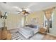 Serene bedroom with neutral tones, large windows, and stylish decor at 7025 Orkney N Ave, St Petersburg, FL 33709