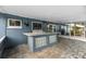 The outdoor kitchen and entertaining area offers a sink, prep area, and privacy at 7025 Orkney N Ave, St Petersburg, FL 33709