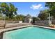 Inviting pool area with wooden deck and storage shed, perfect for outdoor relaxation at 7025 Orkney N Ave, St Petersburg, FL 33709