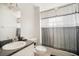 Bathroom showcasing a shower with patterned curtain, toilet, and vanity with a granite counter at 8004 N Brooks St, Tampa, FL 33604